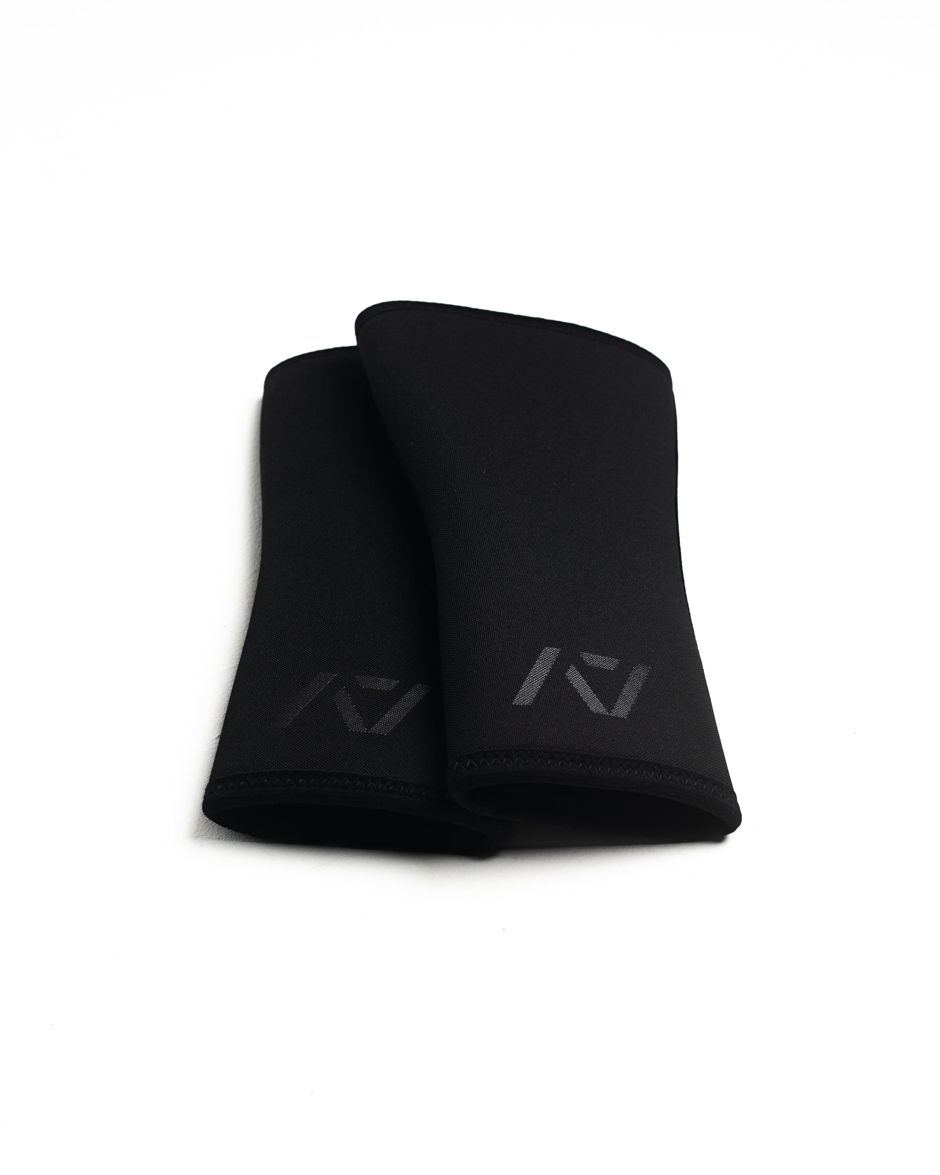 Flat lay of A7 Hourglass Knee Sleeves – Stealth pair, illustrating hourglass design.