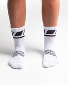 Front view of A7 Crew Socks in Domino White, showcasing mid-shin length and ribbed cuff design.