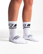 Side profile of A7 Crew Socks in Domino White, highlighting the A7 logo on the ankle and compression-style top.