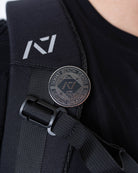 A7 Revive Pin attached to a gym bag strap, showing practical use and symbolic representation for lifters.